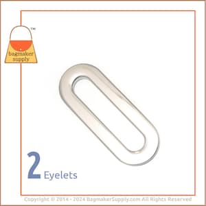 Puede incluir: Dos ojales transparentes de forma ovalada. Los ojales están hechos de un material transparente y están diseñados para la fabricación de bolsos. La imagen incluye el texto "2 Ojales" y el logotipo de Bagmaker Supply.