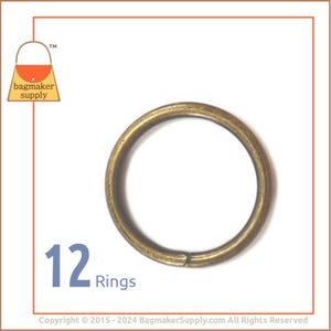 May include: Twelve antique brass rings. The rings are round and have a smooth finish.