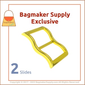 May include: Gold-colored metal slider buckle with a wavy design. The buckle has two slides and is labeled "Bagmaker Supply Exclusive".