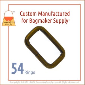 May include: A pack of 54 gold-toned metal rings. The rings are rectangular in shape and have a smooth finish. The rings are designed for use in crafting and making bags.