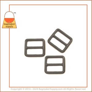 May include: Three dark grey metal rectangle sliders with two bars. The sliders are for bag making and have a matte finish. The logo for Bagmaker Supply is in the upper left corner.