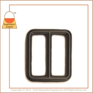 May include: A dark grey rectangular slider buckle with two openings, suitable for bag straps and crafting. The buckle is made of a robust material and is shown against a white backdrop. The bagmaker supply logo is in the top left corner.