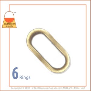 May include: Six gold oval metal rings. The rings are about 1 inch in diameter.