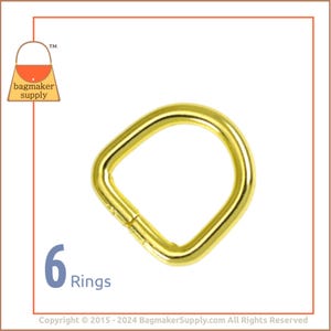 May include: Six gold-toned metal D-rings. The rings are approximately 1 inch in diameter.