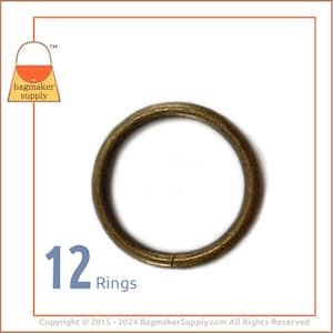 May include: Twelve antique brass rings. The rings are round and have a smooth finish.