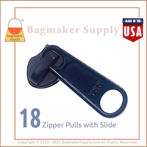 May include: A dark blue zipper pull with a slide. The pull has a round hole and the text "YKK" is visible on the side. The pull is 18 zipper pulls with slide.