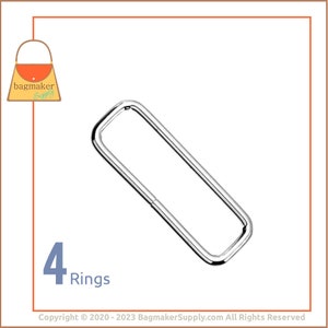 Peut inclure: Quatre anneaux en métal argenté, chacun de forme rectangulaire. Les anneaux sont disposés en rangée, avec le texte "4 Rings" en dessous.