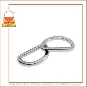 May include: Two silver metal D-rings, one slightly larger than the other, are interlocked. The rings are smooth and shiny.