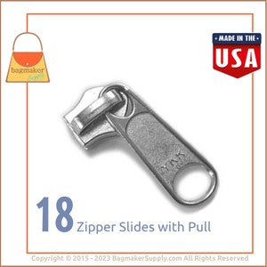 May include: A silver zipper slide with a pull is shown in close-up. The image shows 18 zipper slides with pull. The text "MADE IN THE USA" is in a red and blue shield. The Bagmaker Supply logo is in the upper left corner.