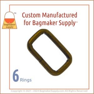 May include: A rectangular, antique brass-colored metal ring. The image includes the text "Custom Manufactured for Bagmaker Supply" and "6 Rings". The logo for Bagmaker Supply is in the upper left corner.