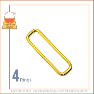 May include: Four gold-coloured metal rings, each with a rectangular shape. The rings are arranged in a row, with the text "4 Rings" below them.