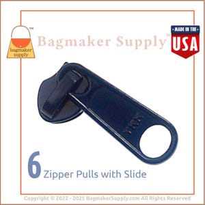 May include: A navy blue zipper pull with a slide, featuring the text "YKK". The image includes the text "6 Zipper Pulls with Slide" and the logo for Bagmaker Supply. The product is labeled "Made in the USA".