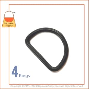 May include: Four black D-rings, each with a diameter of approximately 2 inches. The rings are made of a durable plastic material and are ideal for use in crafting projects.