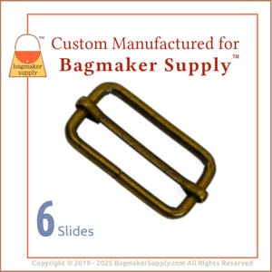 May include: A pack of six gold-toned metal slider buckles. The buckles are rectangular with a smooth finish. The text "Custom Manufactured for Bagmaker Supply" is printed above the buckles.
