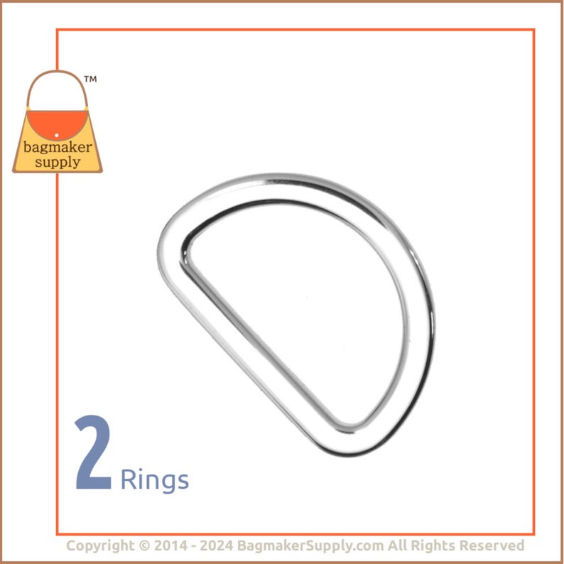 May include: Two silver D-rings, a type of metal hardware used in crafting and sewing projects. The rings are shown against a white background.