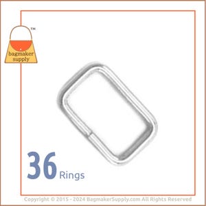 May include: A pack of 36 silver metal rings. The rings are rectangular in shape and are commonly used for attaching straps or handles to bags or other projects.