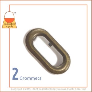 May include: Two antique brass oval grommets, a type of metal reinforcement used in leather goods and crafts.