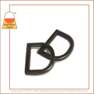 May include: Two black metal D-rings with a teardrop shape. The rings are interlocked.