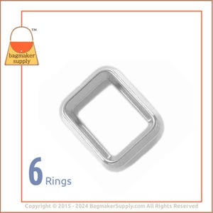 May include: Six silver metal rings, each with a square shape and a smooth, polished finish. The rings are arranged in a loose pile, with one ring slightly raised above the others.