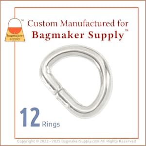 Puede incluir: Un paquete de 12 anillos en D de metal plateado. Los anillos tienen un diámetro de aproximadamente 2,5 cm. Los anillos se utilizan para hacer bolsos y otras manualidades.