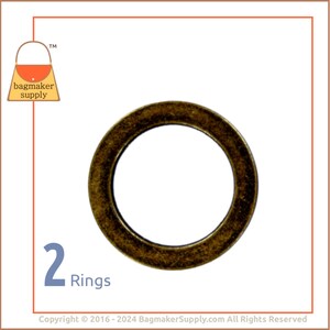 May include: Two antique gold metal rings. The rings are round and have a smooth finish.