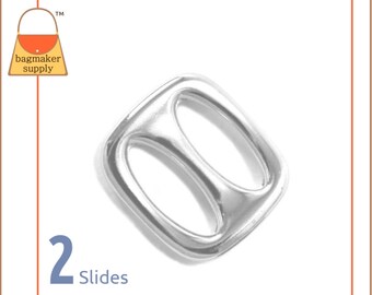 May include: Two silver metal slider buckles. The buckles are square shaped with two oval openings. The text "2 Slides" is printed below the buckles.