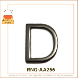 May include: A silver-toned D-ring hardware fitting, also known as a D-ring buckle, for use in bag making and other crafts. The ring is approximately 2 inches in diameter. The product code is RNG-AA266.