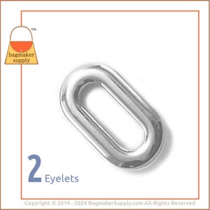 May include: Two silver oval-shaped eyelets. The eyelets are shiny and have a smooth surface.