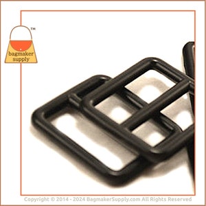 May include: Close-up of several black metal square rings, possibly for bag making or crafting. The rings are stacked and slightly overlapping, with rounded corners. The background is white, and the image includes the "bagmaker supply" logo.