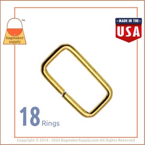 May include: A pack of 18 gold-colored metal rings, each ring is rectangular in shape. The rings are made in the USA.  The image shows one ring, with the text "18 Rings" below it.