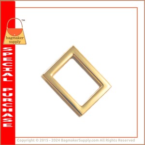 May include: Gold metal D-ring hardware for bags and purses. The ring is rectangular with rounded corners and a smooth finish.