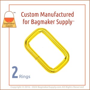 May include: Two gold-colored metal rings, each with a rectangular shape. The rings are shown against a white background. The text "Custom Manufactured for Bagmaker Supply™" is displayed above the rings.