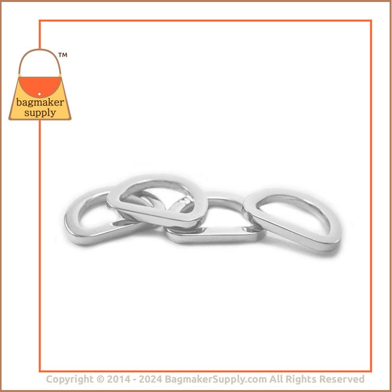 May include: Four silver metal D-rings, stacked on top of each other. The rings are smooth and shiny.