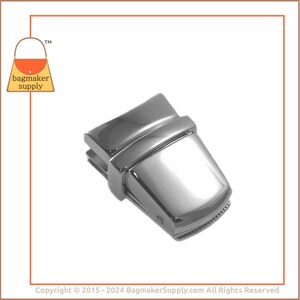May include: Silver-toned metal purse closure with a rectangular shape and a bevelled edge. The closure has a smooth, polished finish.