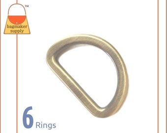 May include: Six gold-toned metal D-rings. The rings are approximately 1 inch in diameter.