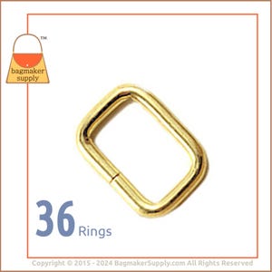 May include: A pack of 36 gold-toned metal rings. The rings are rectangular in shape and have a smooth finish. They are ideal for attaching to straps, handles, or other accessories.