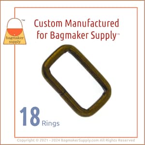 May include: A set of 18 gold-toned metal rings. The rings are rectangular in shape and have a smooth finish. The rings are designed for use in crafting and making bags.