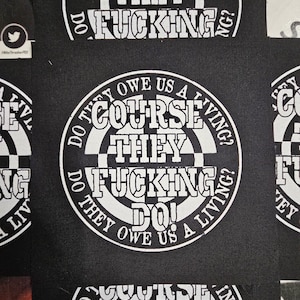 May include: Black and white patches with the text "COURSE THEY FUCKING DO!" in a circular design. The phrase "DO THEY OWE US A LIVING?" surrounds the central text. The patches have a checkerboard pattern.
