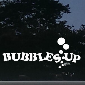 May include: White vinyl decal with the text "Bubbles Up" and a series of white circles representing bubbles.