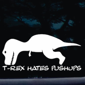 May include: White vinyl sticker of a T-Rex doing a push-up with the text "T-Rex hates pushups" underneath.
