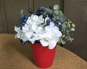 Red white and blue 4th of July arrangement patriotic arrangement red planter with white hydrangeas and blue berries 4th July arrangement