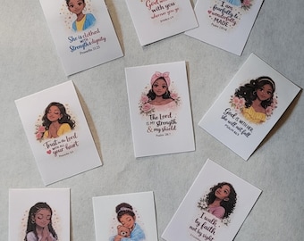 May include: A collection of rectangular cards featuring illustrations of Black women with floral accents. Each card displays a different inspirational quote from the Bible, such as "She is clothed with strength & dignity" and "God will be with you wherever you go."