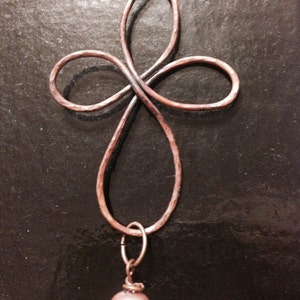 Hand made beaten copper Celtic cross with taupe glass pearl dangle.  Comes on your choice of copper chain or black suede with handmade clasp