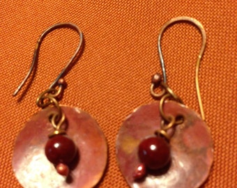 Hand crafted copper discs with cranberry red bead and deep red fire patina