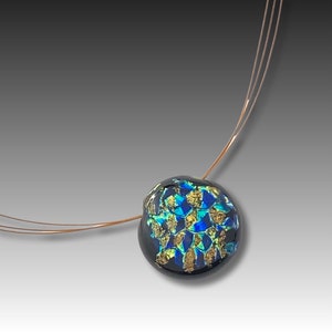 May include: A necklace with a round, black glass pendant featuring a blue and gold mosaic design.