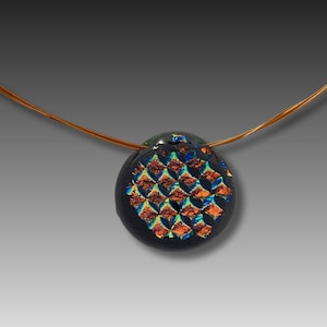 May include: A black glass pendant necklace with a copper wire chain. The pendant features a geometric pattern of iridescent orange, blue, and green.