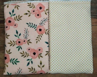 May include: Two fabric squares, one with a pink floral pattern and the other with a white background and small gold polka dots.