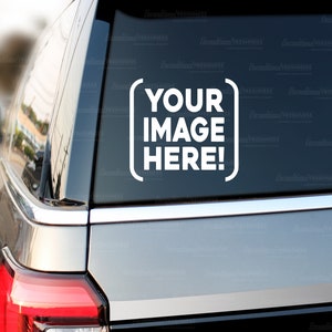 May include: A gray car with a white sticker on the back window that says "YOUR IMAGE HERE!" in a white box.