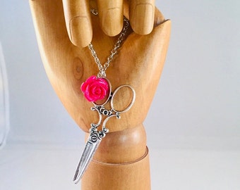 Scissor necklace with eye-catching red rose