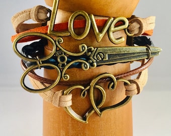 Leather scissor bracelet with antique bronze metal scissor, hearts, and love! Stylish!